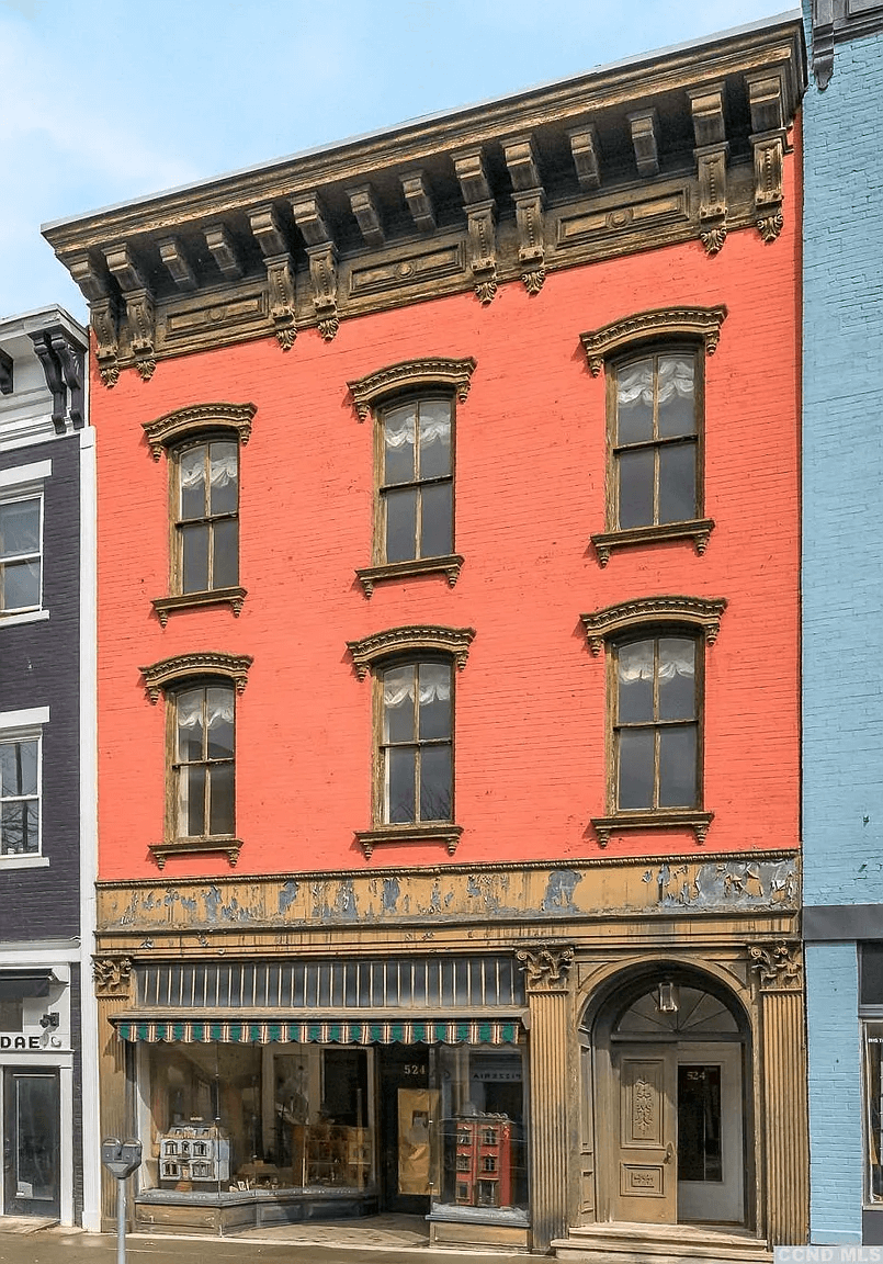 exterior of the building with a bracketed cornice and cast iron storefront