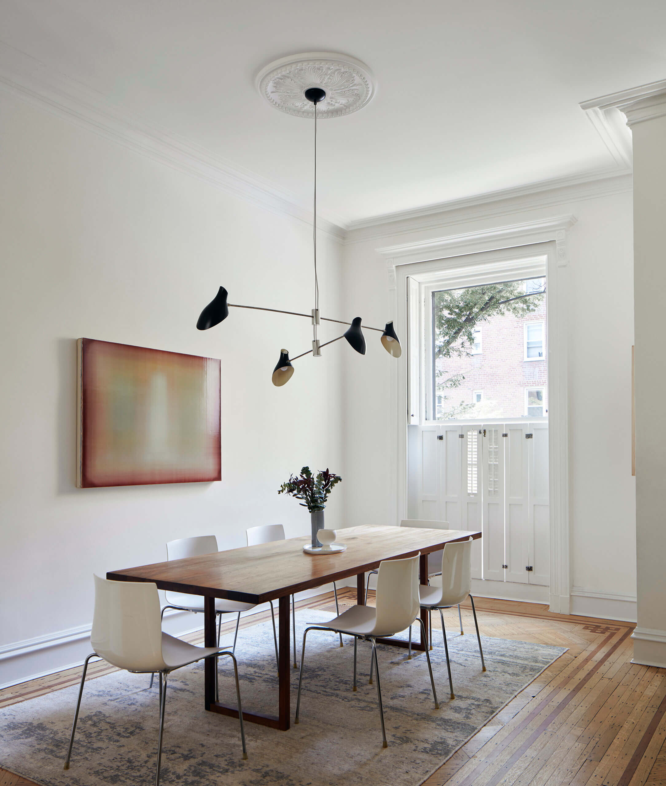 DINING ROOM with a ceiling medallion and interior shutters