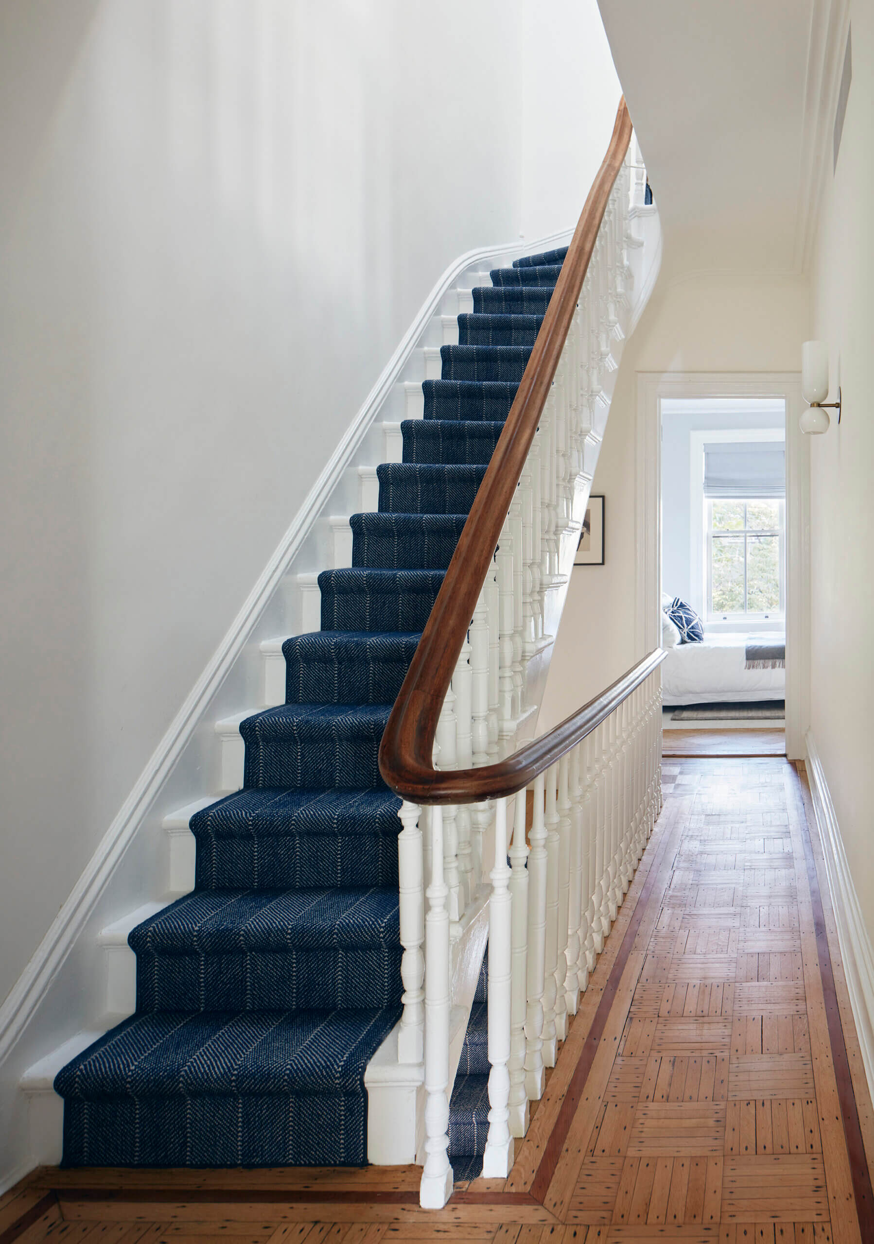 STAIR painted white with blue runner