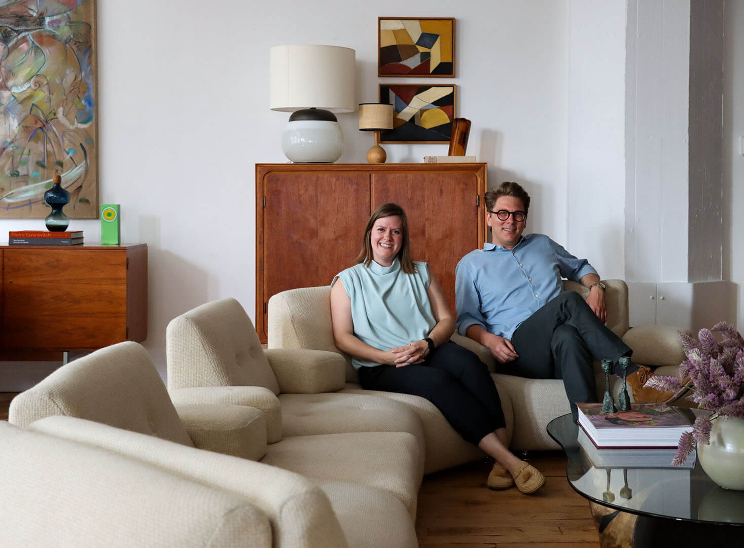 the architects sitting on a sofa in the showroom