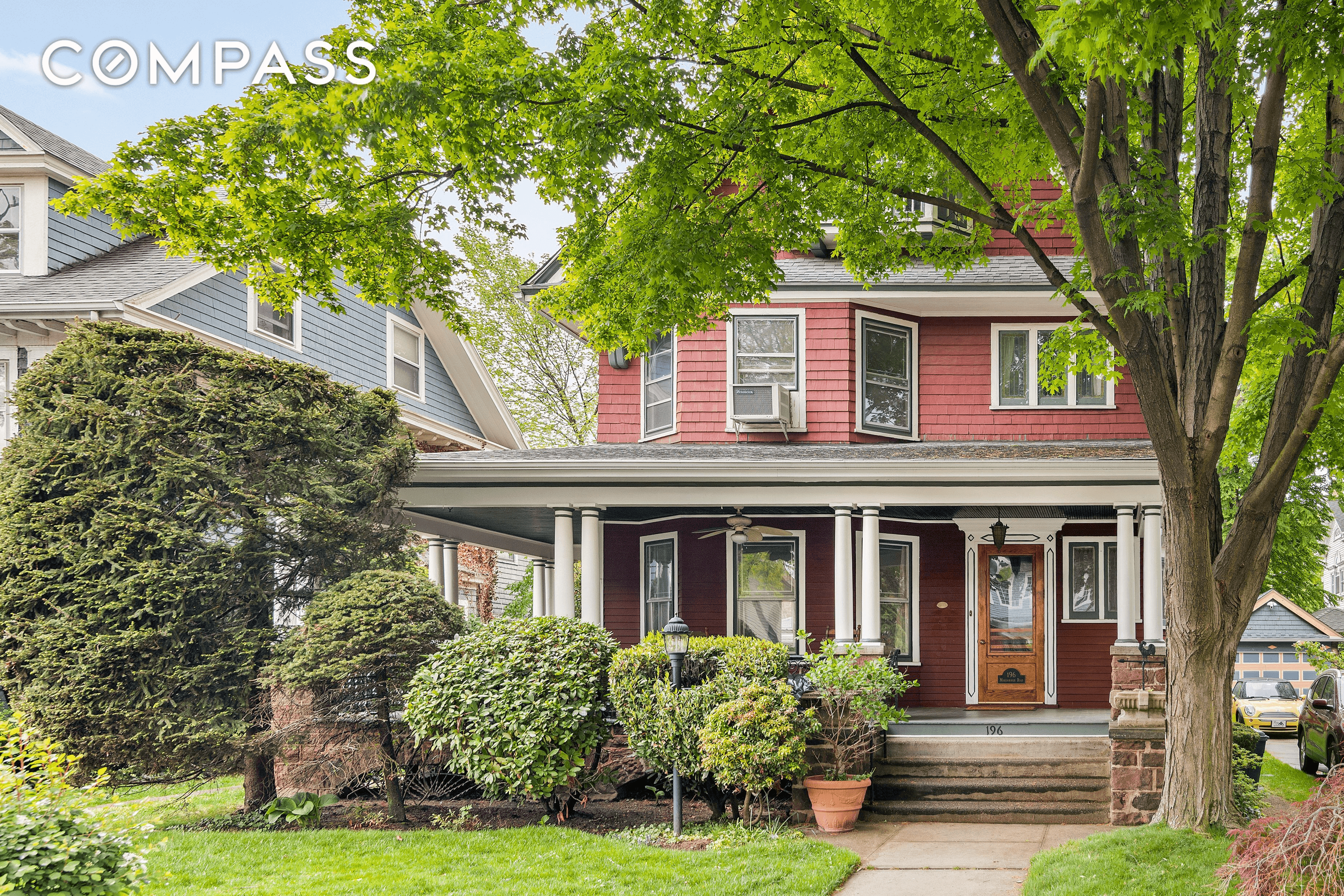 exterior of red shingled house with porch