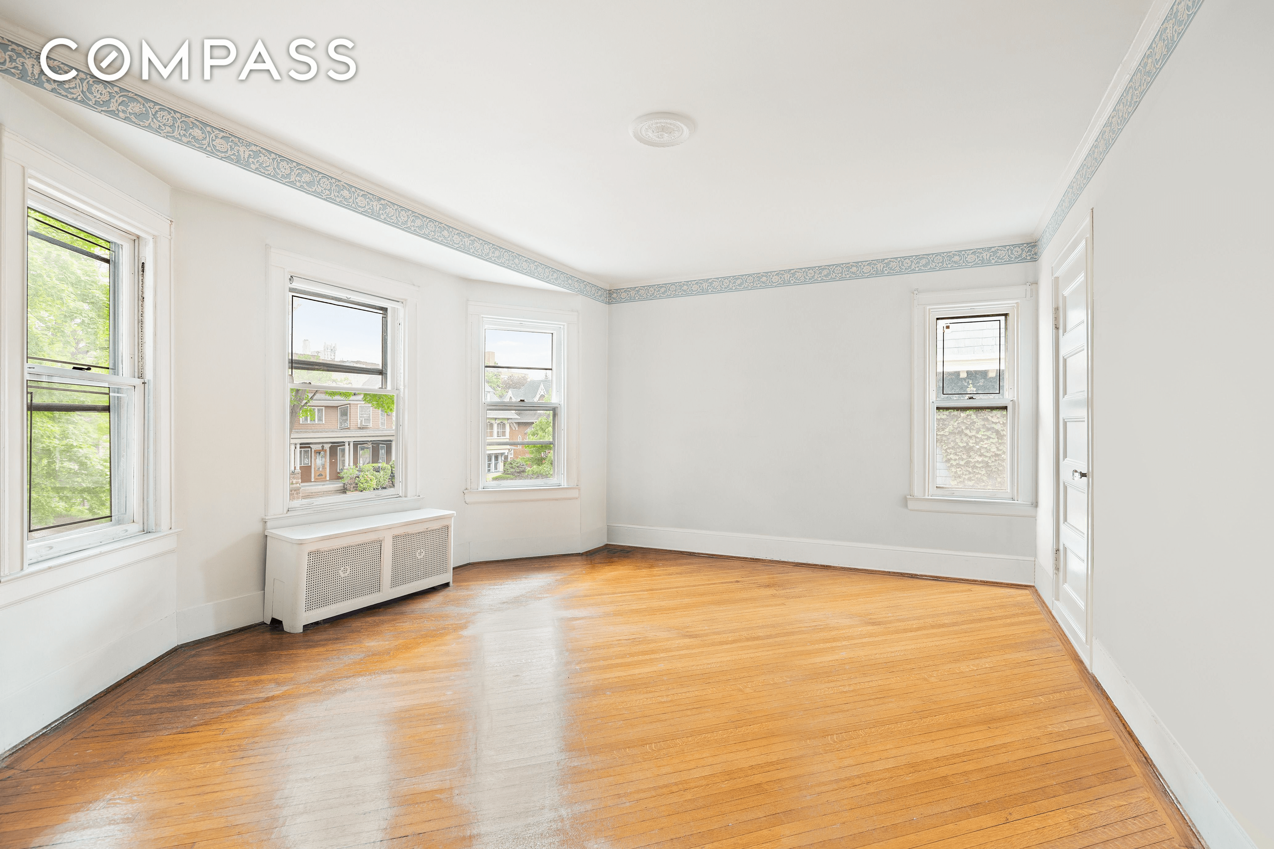 bedroom with wood floor and wallpaper border