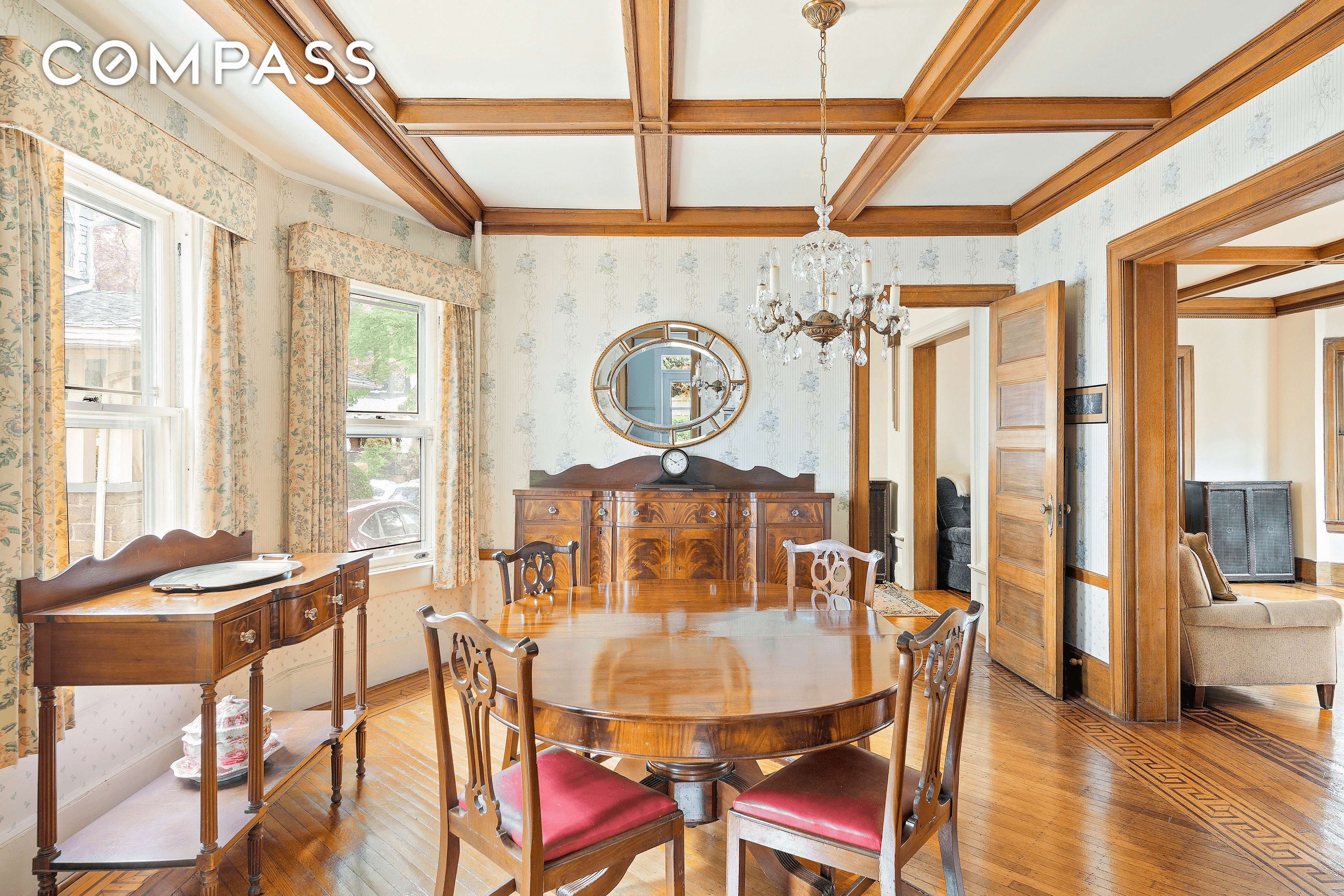 dining room with wallpaper and coffered ceiling