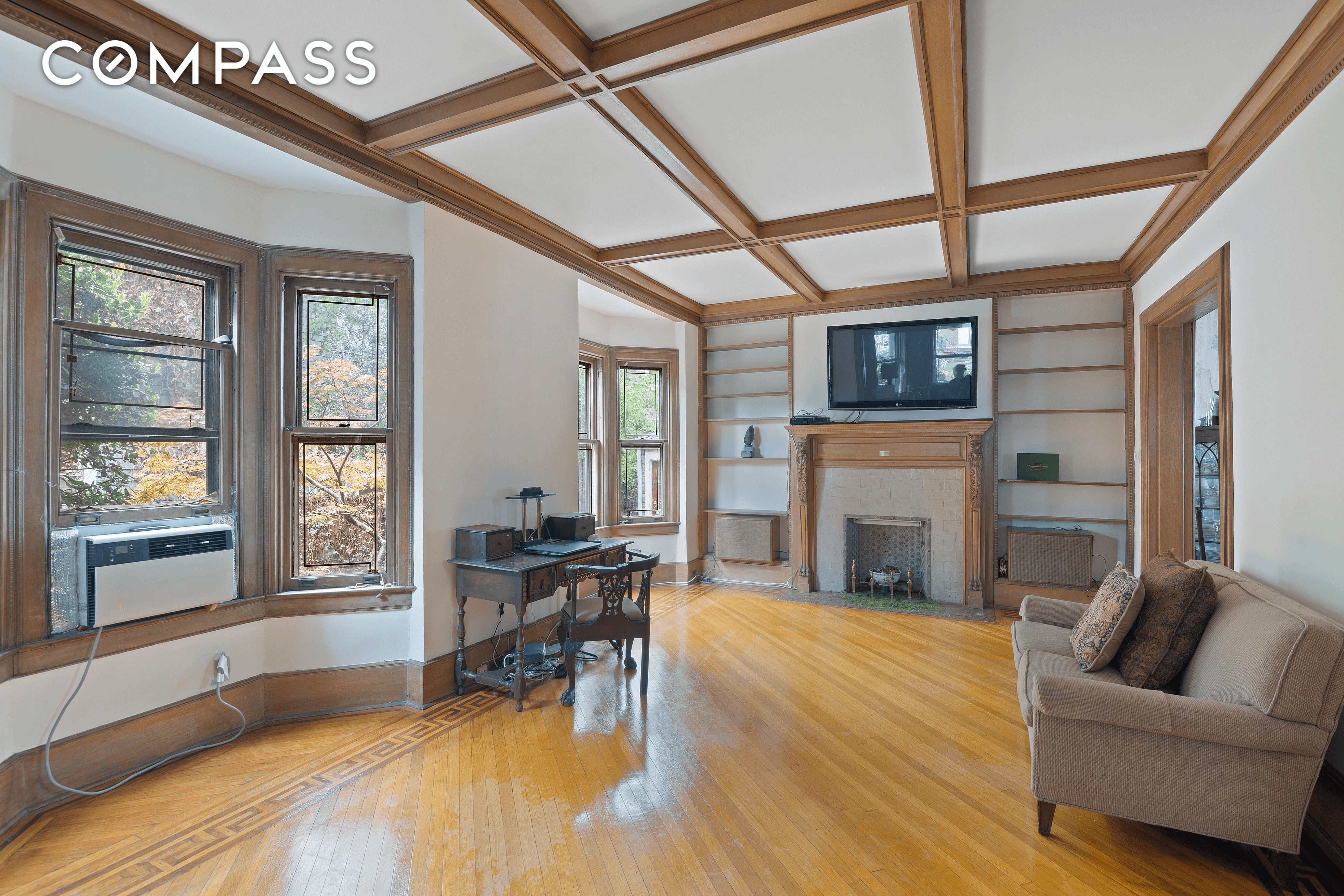 library with mantel and coffered ceiling