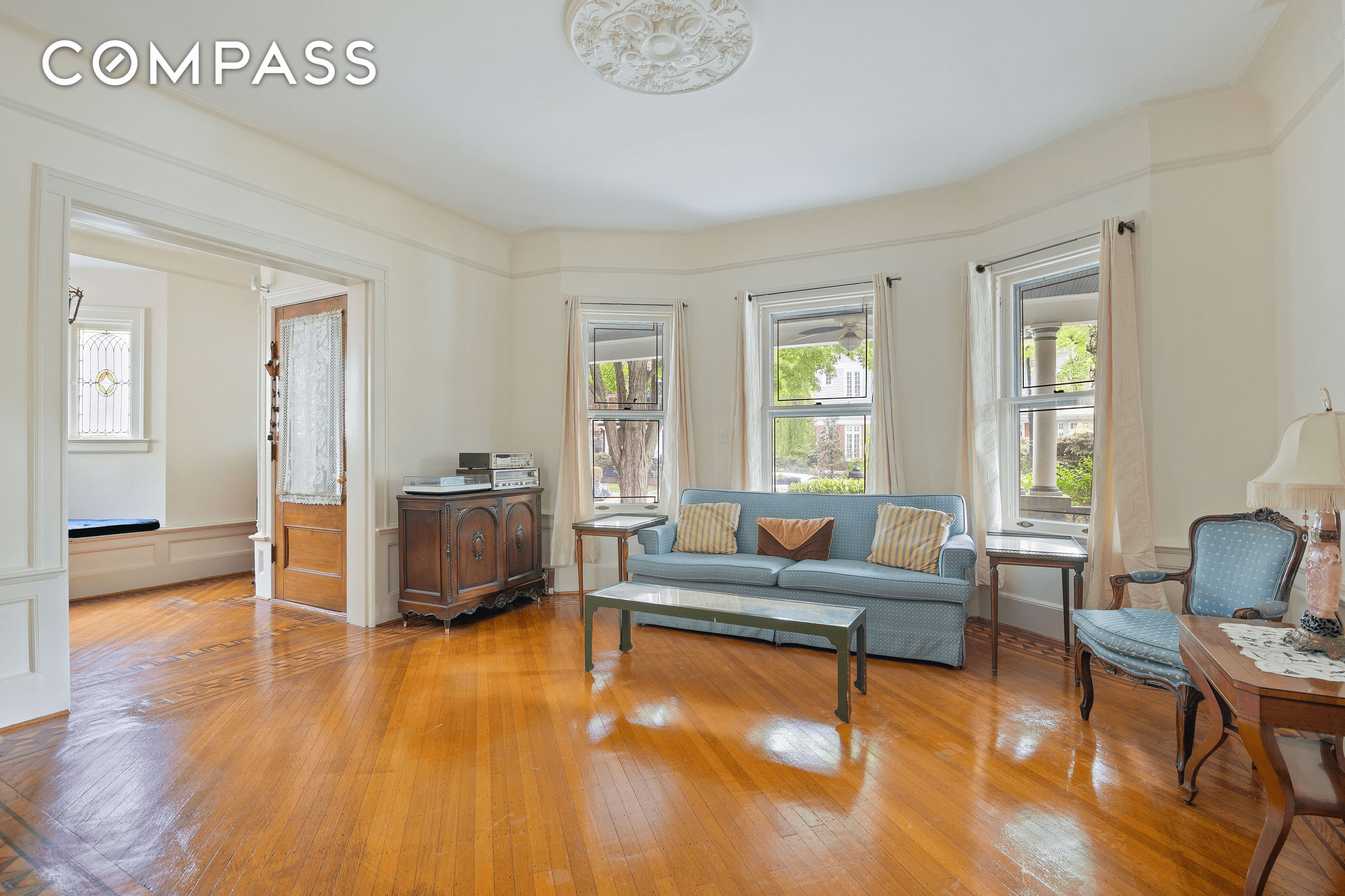 parlor with ceiling medallion and view to porch