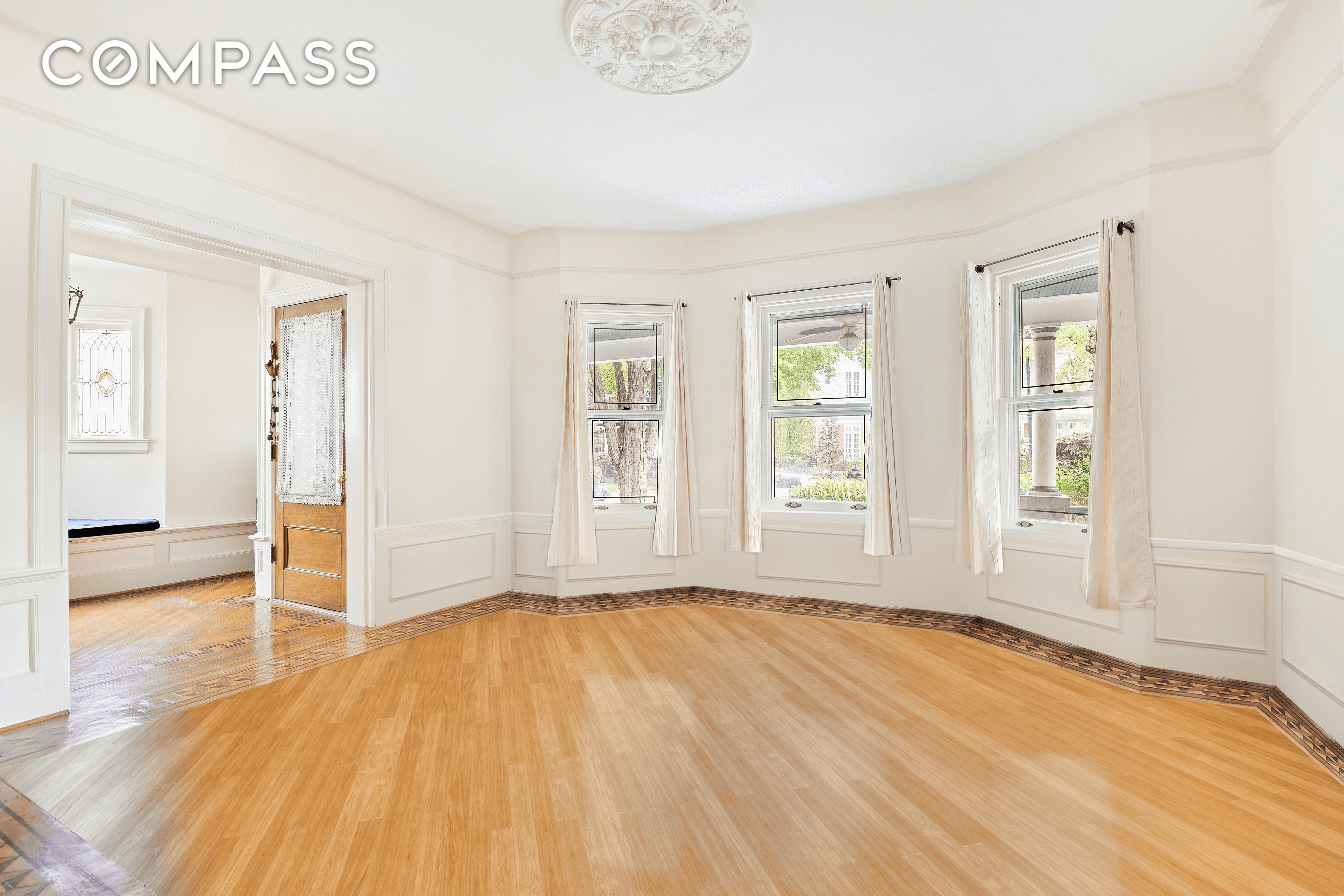 parlor with ceiling medallion and view to porch