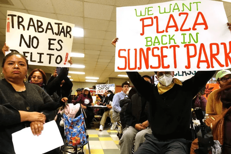 sunset park vendors holding signs