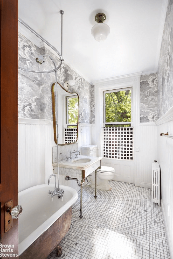 bathroom with wainscoting and clawfoot tub