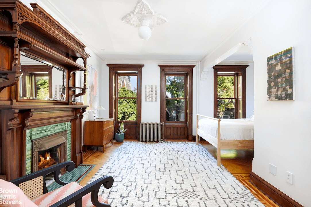 bedroom with bed niche and a wood mantel