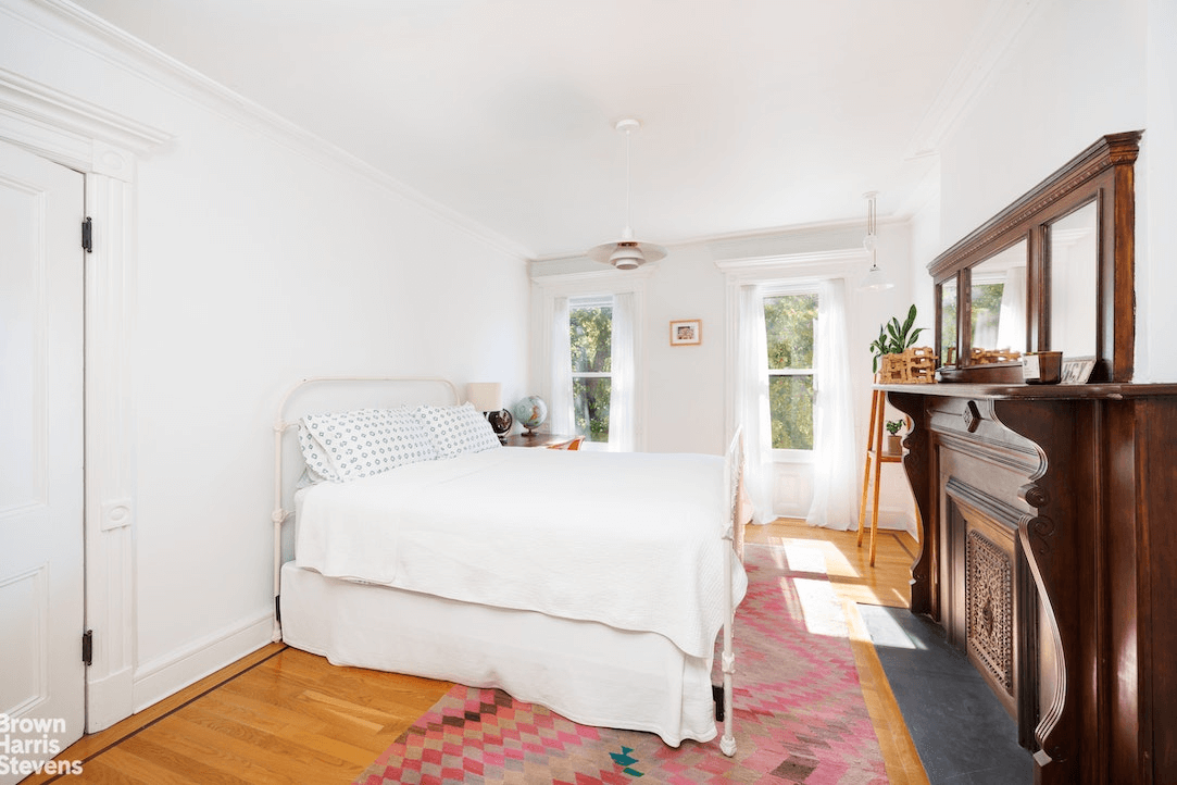 bedroom with wood mantel