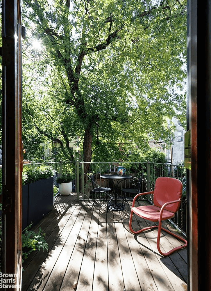 rear deck off the kitchen with room for a small table and stairs down to the garden