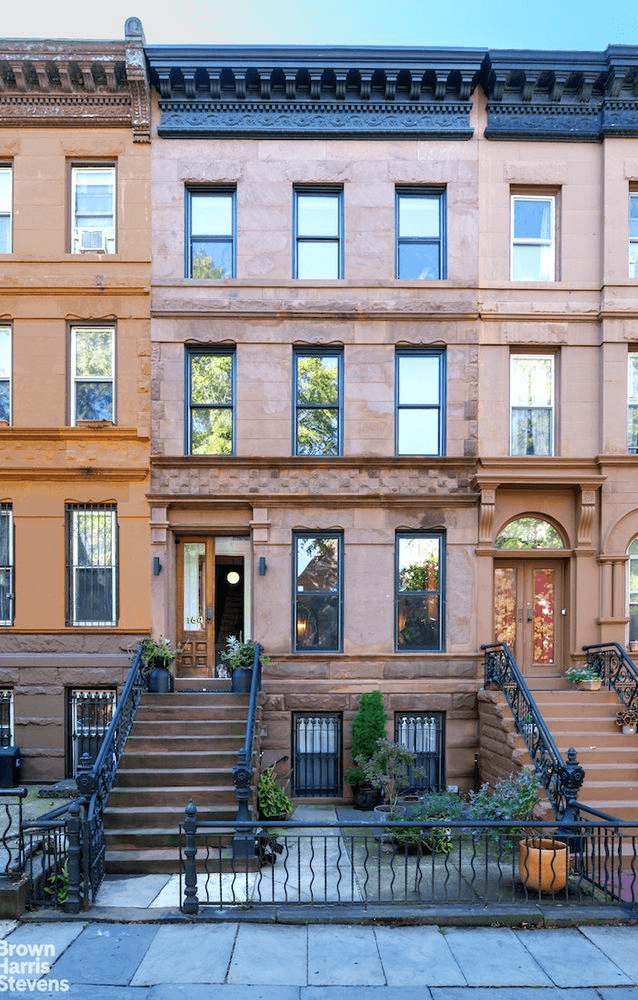 view of brownstone with stoop and bracketed cornice