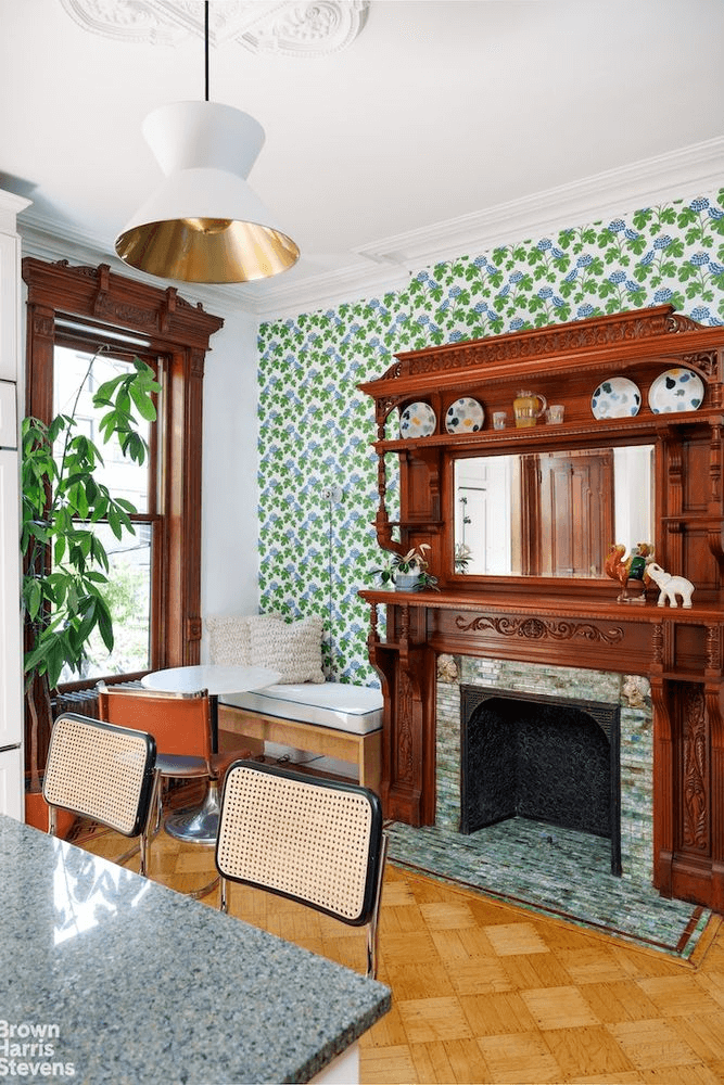 floral wallpaper in dining area with mantel