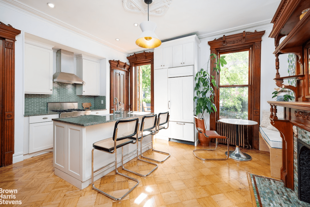 kitchen with white cabinets and green tile backsplash