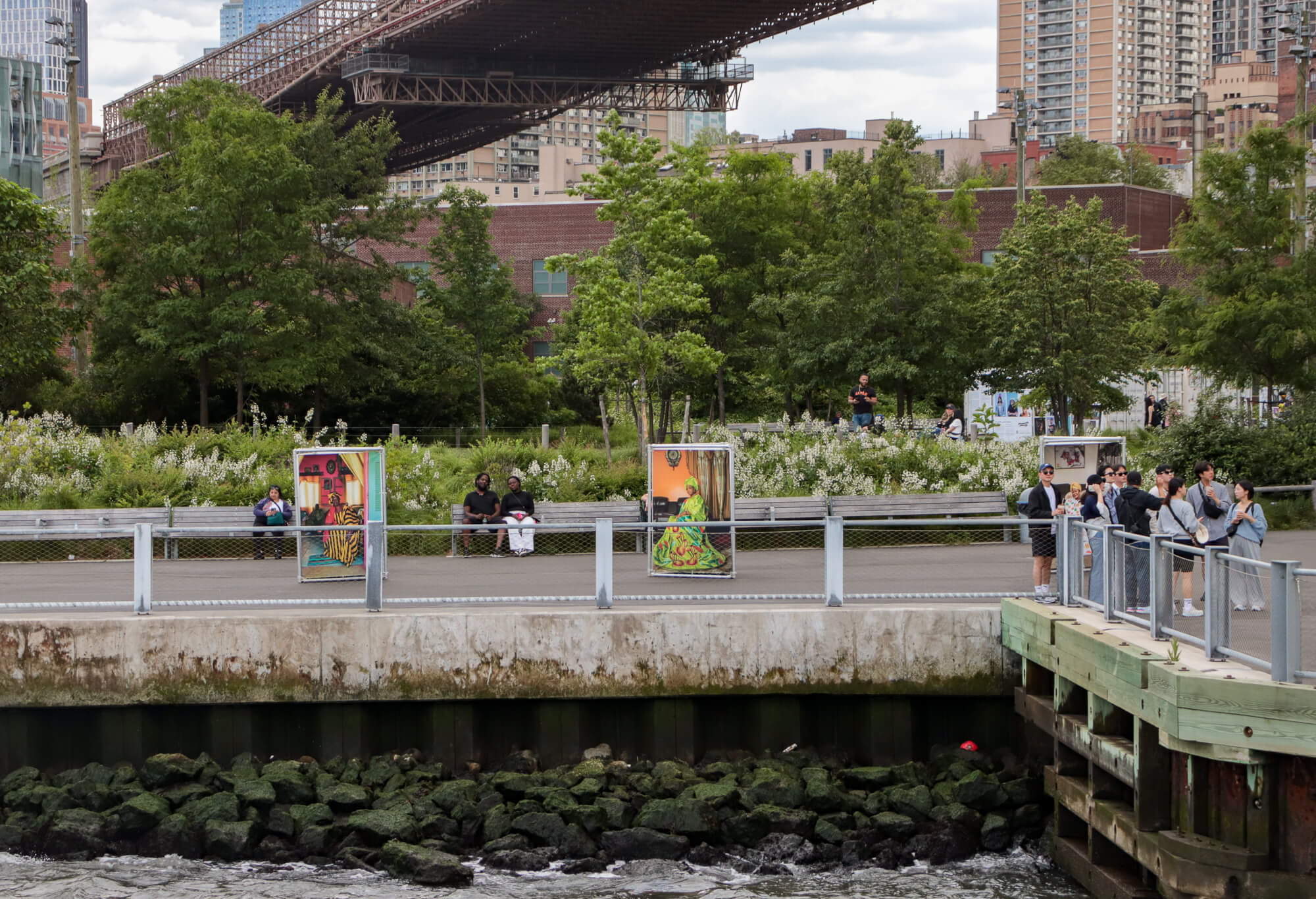 people sitting on benches along the waterfront