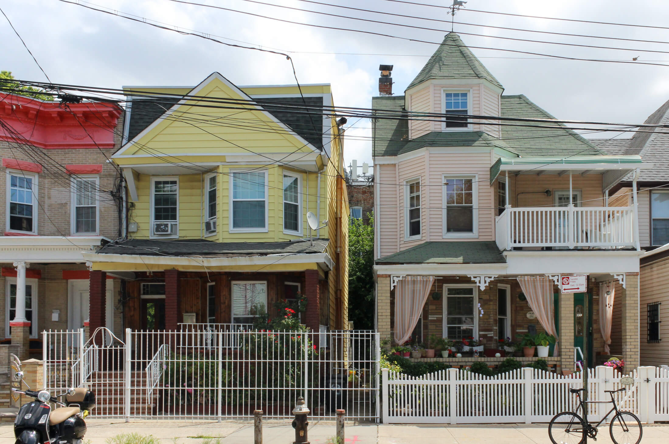 a yellow and a pink house