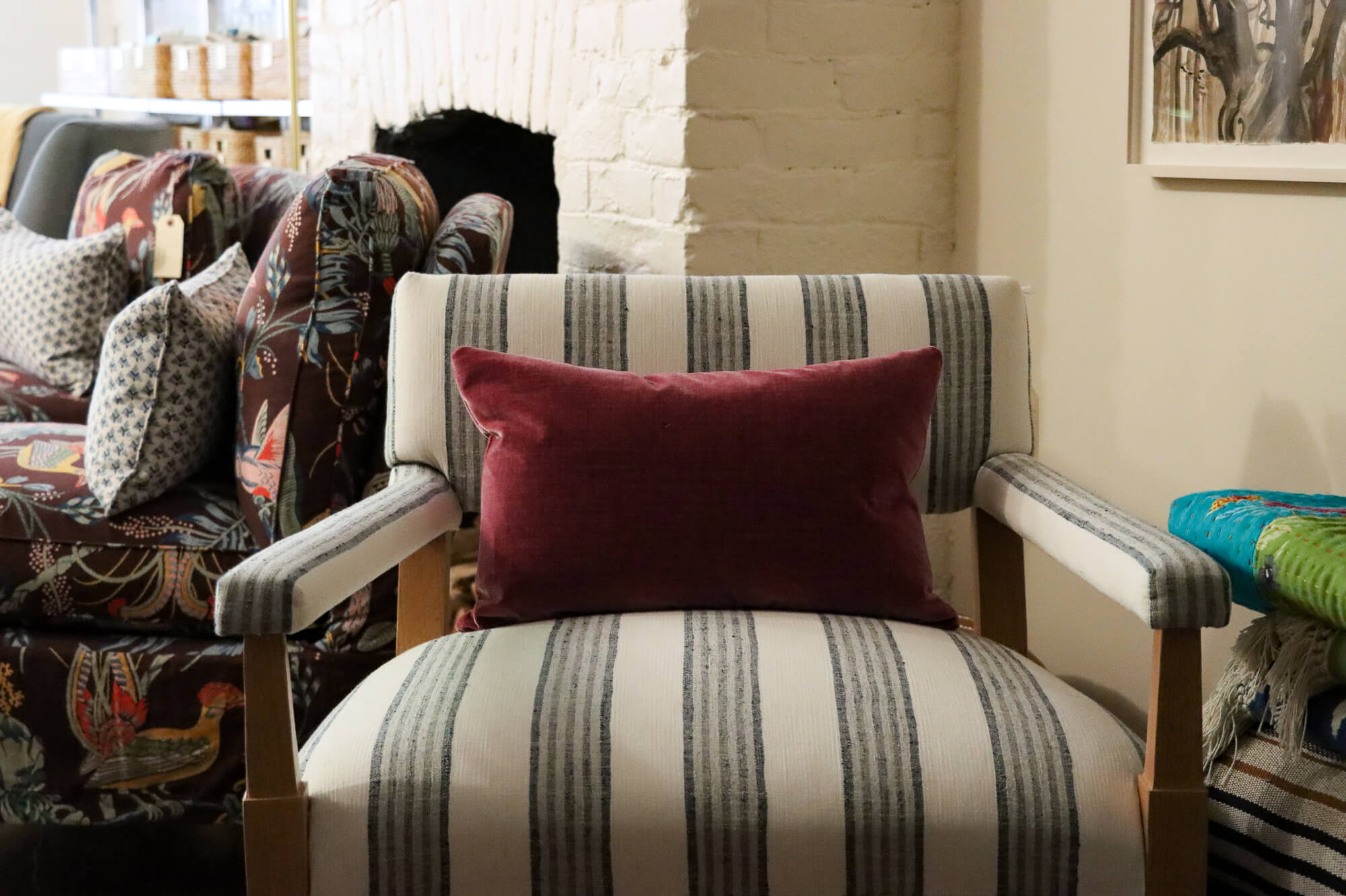 a striped chair with a velvet pillow