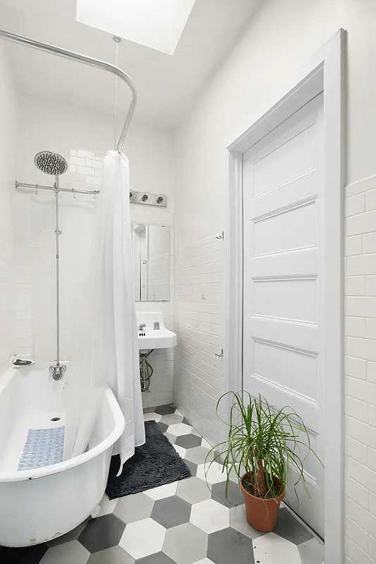 bathroom with hex tile floor and claw foot tub