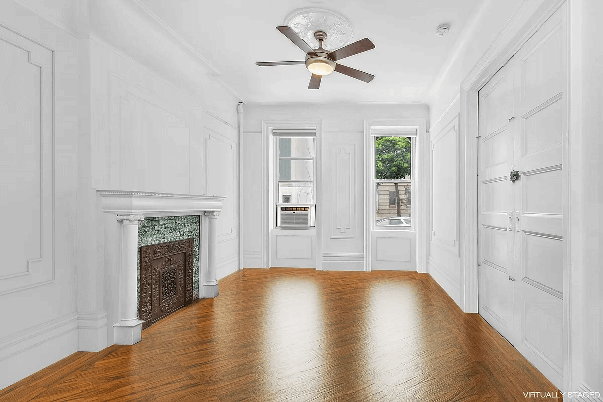 virtually staged room with mantel with green tile