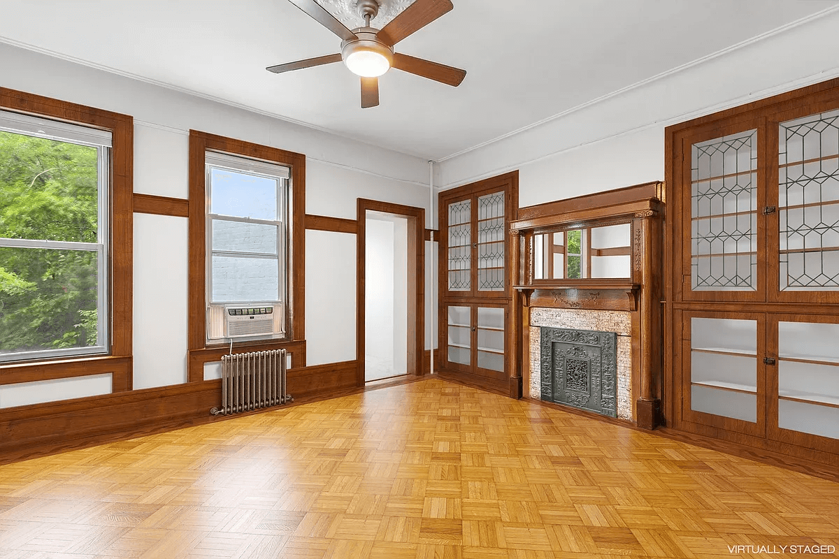 virtually staged parlor with mantel and built-ins