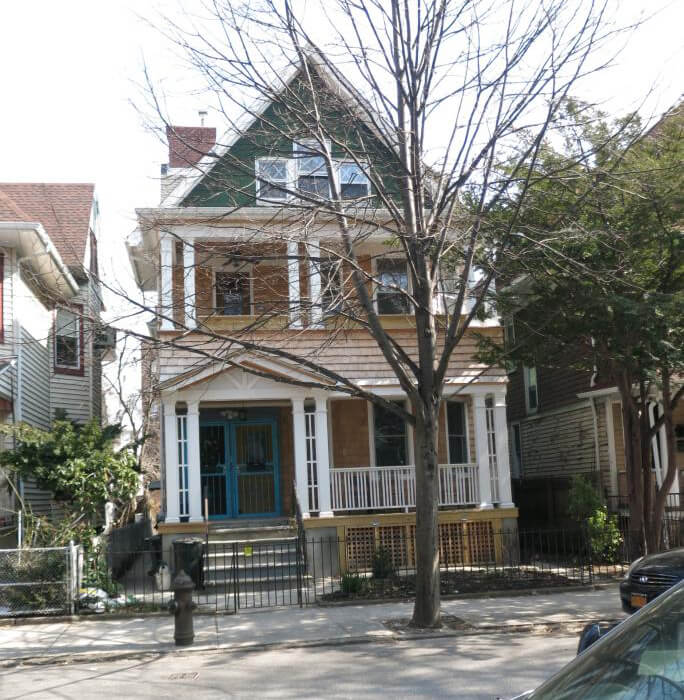 exterior of the shingled house with porches