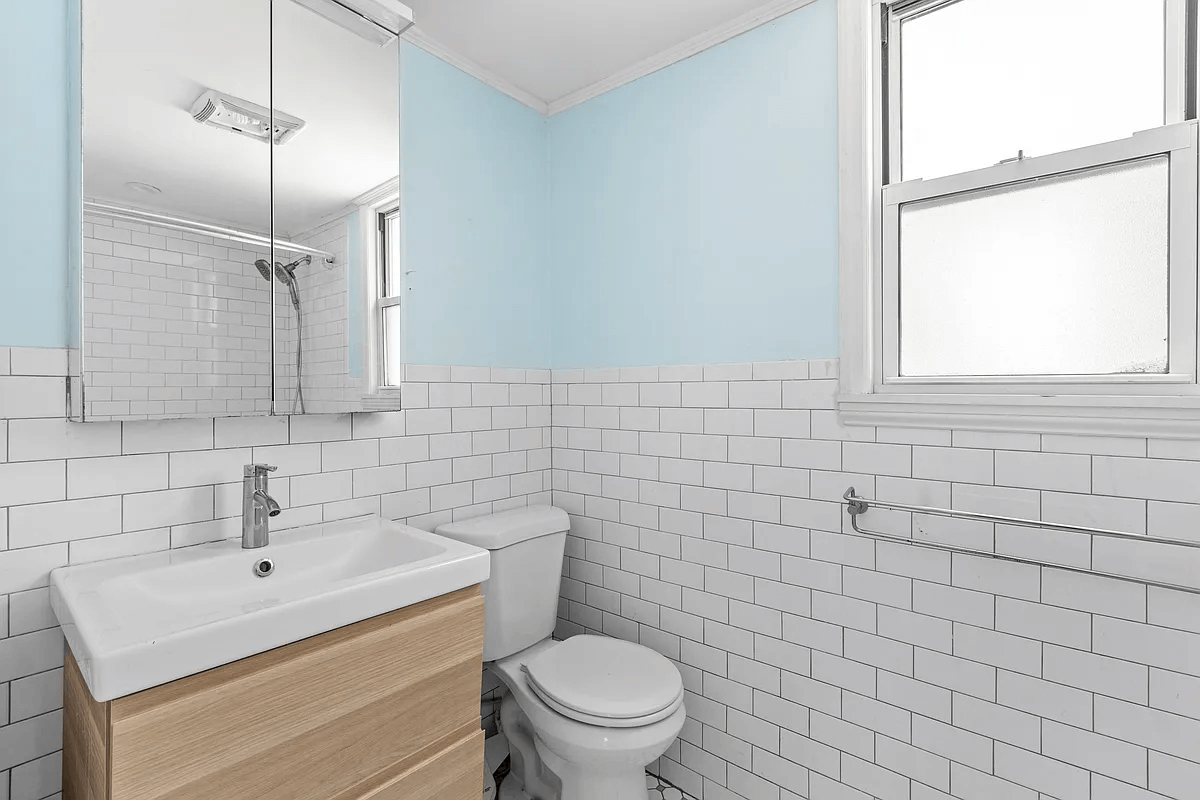 bathroom with white subway tile walls