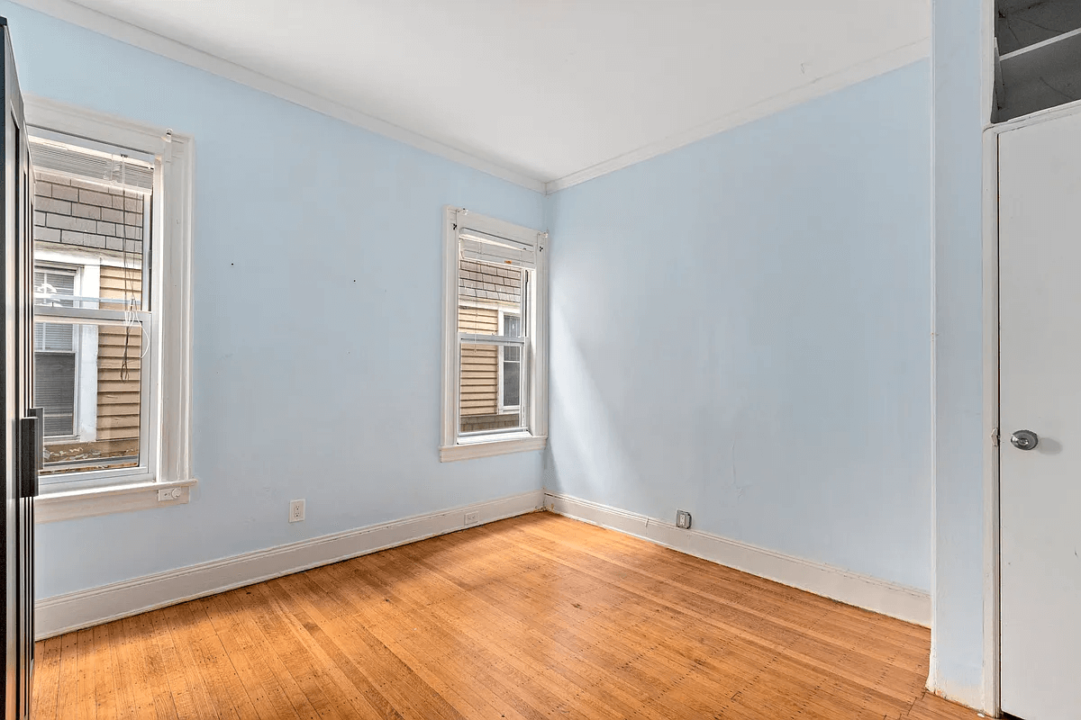 bedroom with blue walls and two windows