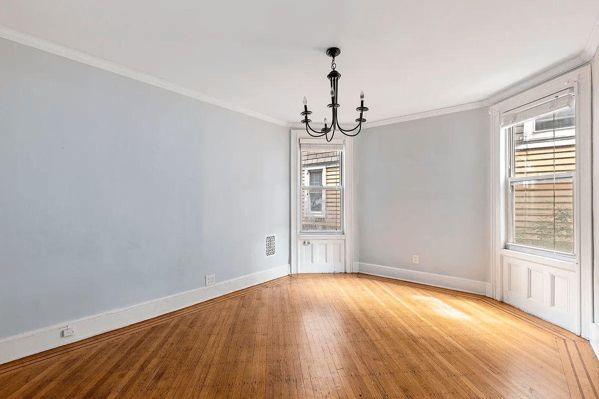 the dining room with two exposures and a chandelier