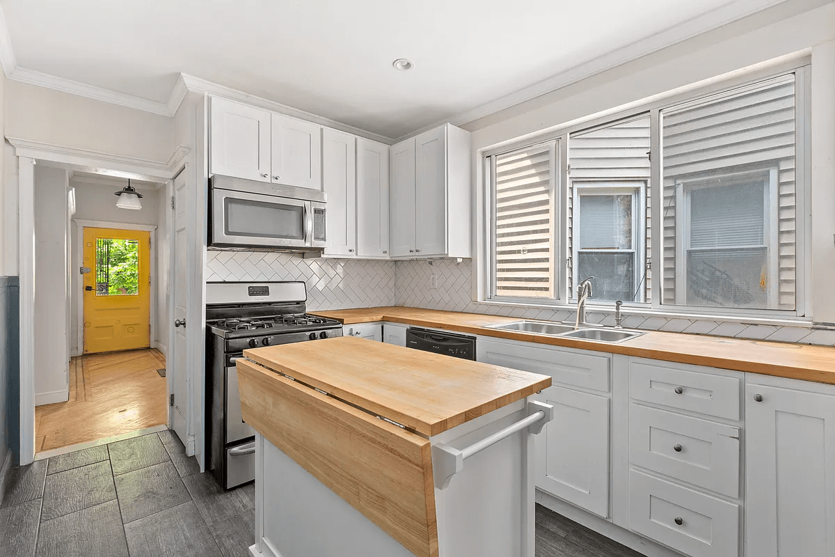 kitchen with white cabinets and subway tile backsplash