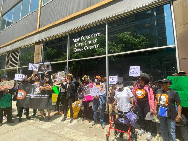 tenants rallying in front of court building