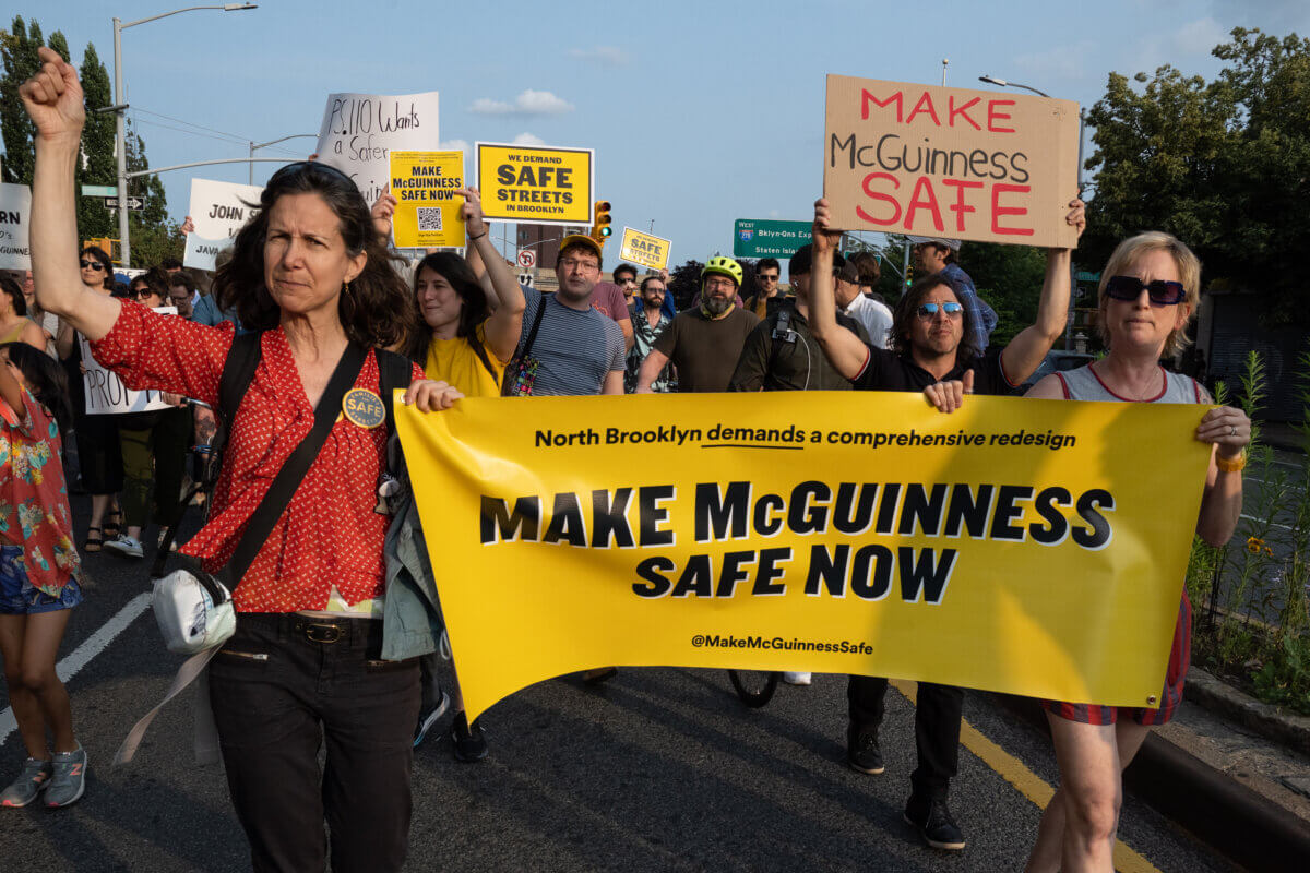 people holding a banner reading make mcguinness safe now