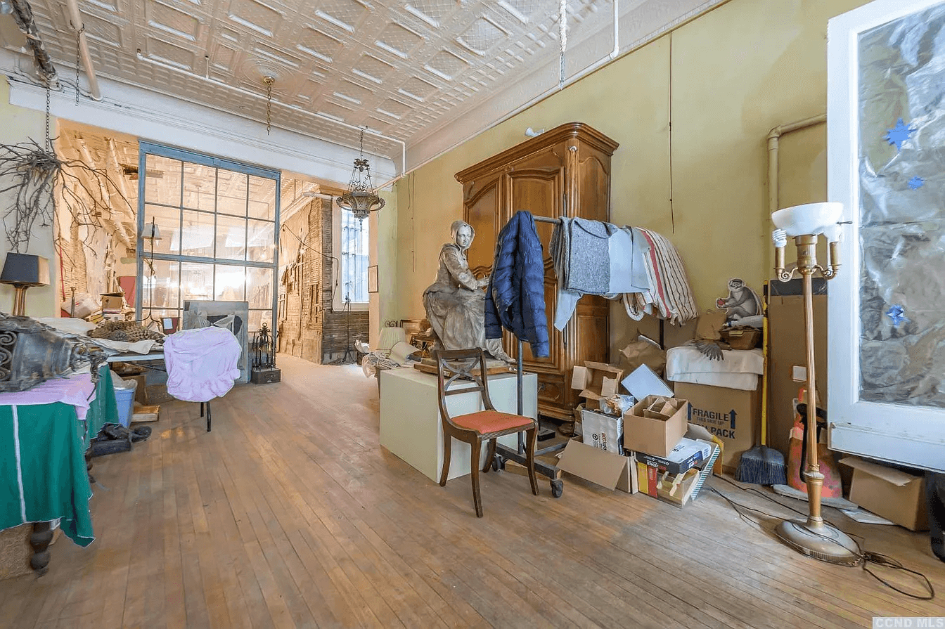 inside of first floor with a tin ceiling and wood floor