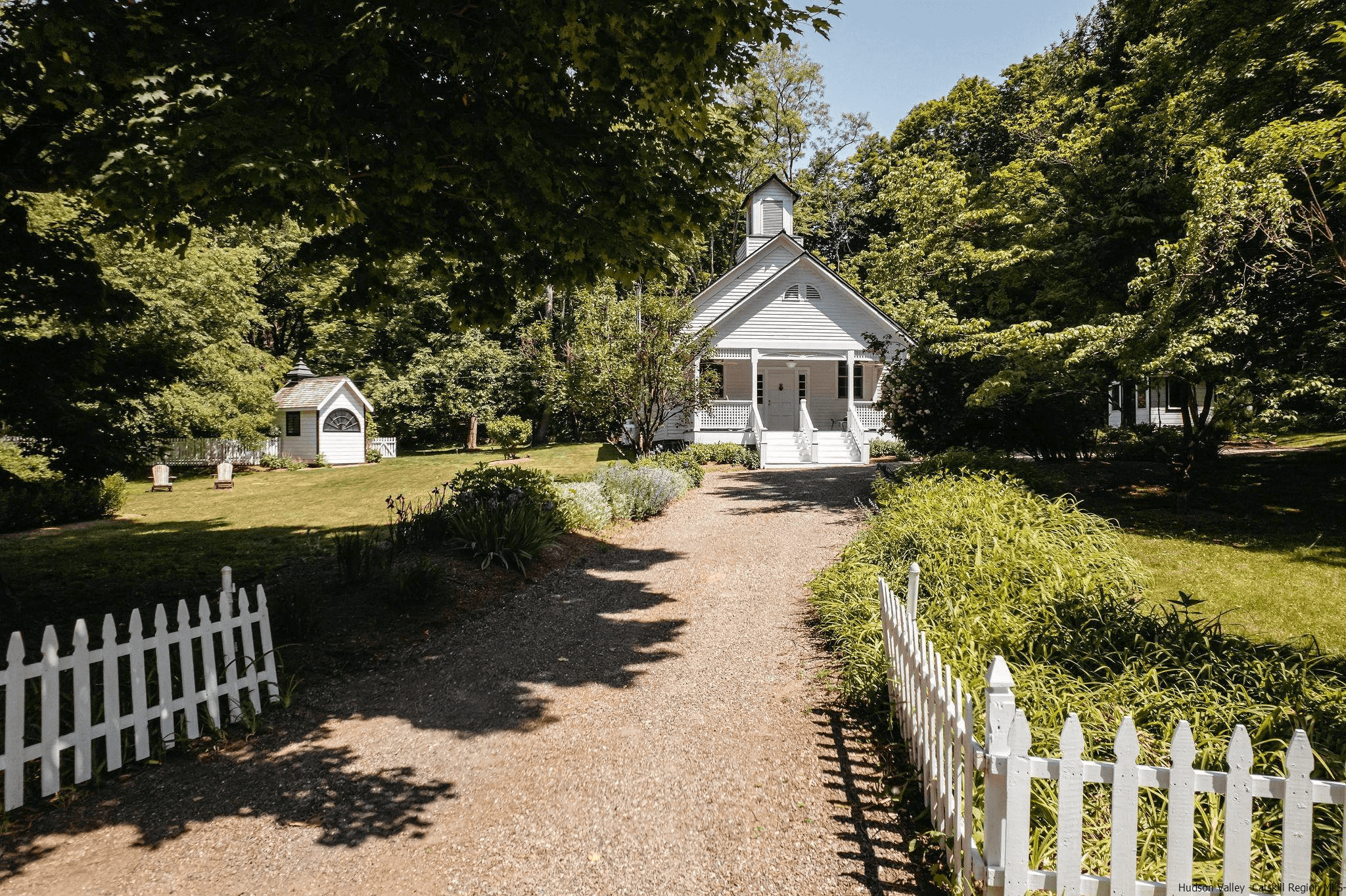 schoolhouse- white picket fence around a frame schoolhouse in kingston