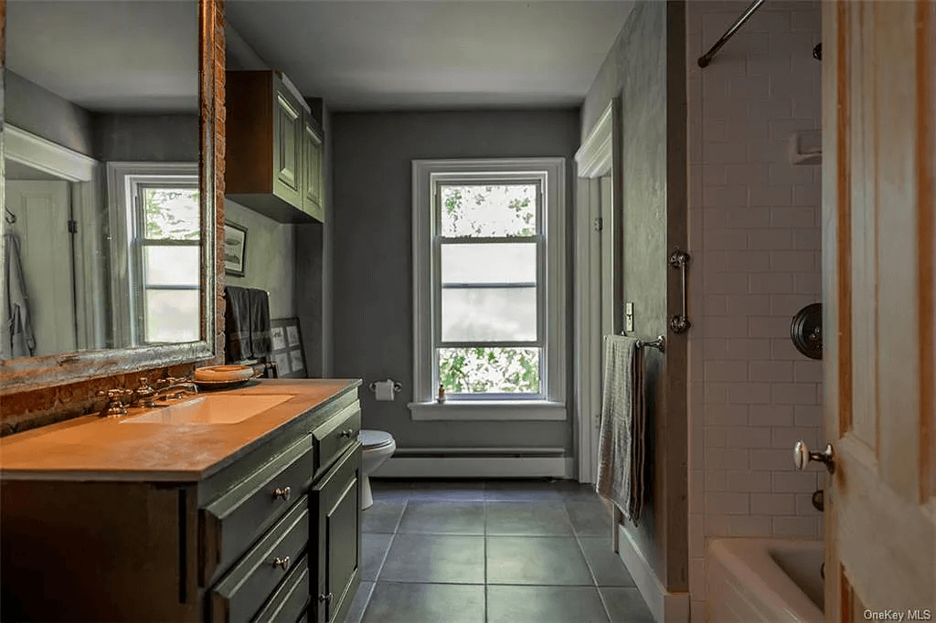 bathroom with white fixtures and dark gray walls