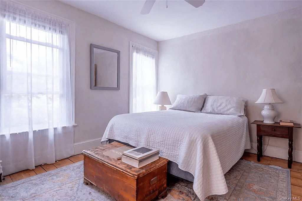 bedroom with ceiling fan and two windows