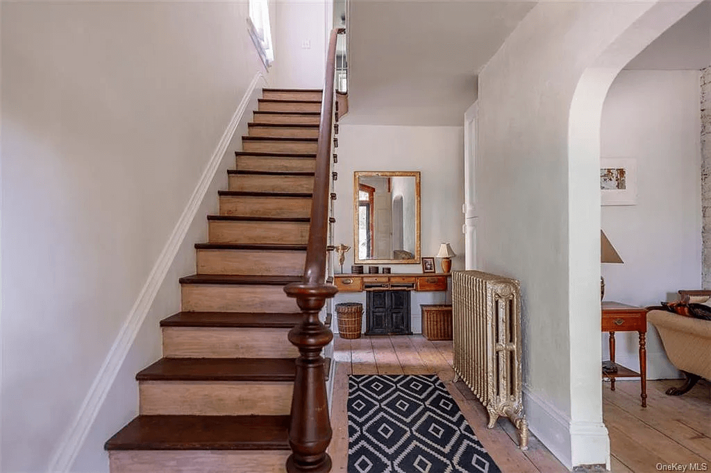 entry hall with original newel post and stairs up to bedrooms on second floor