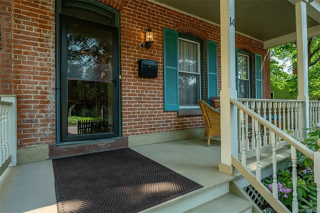 front porch with blue shutters framing windows
