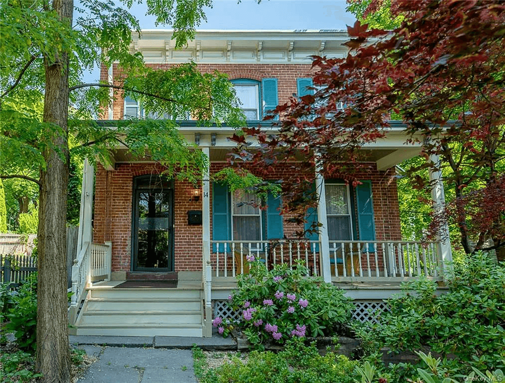 red brick exterior with bracketed cornice and front porch