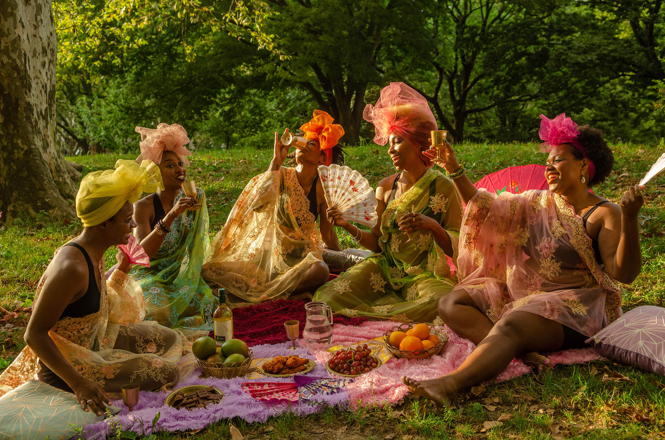 people around a picnic blanket