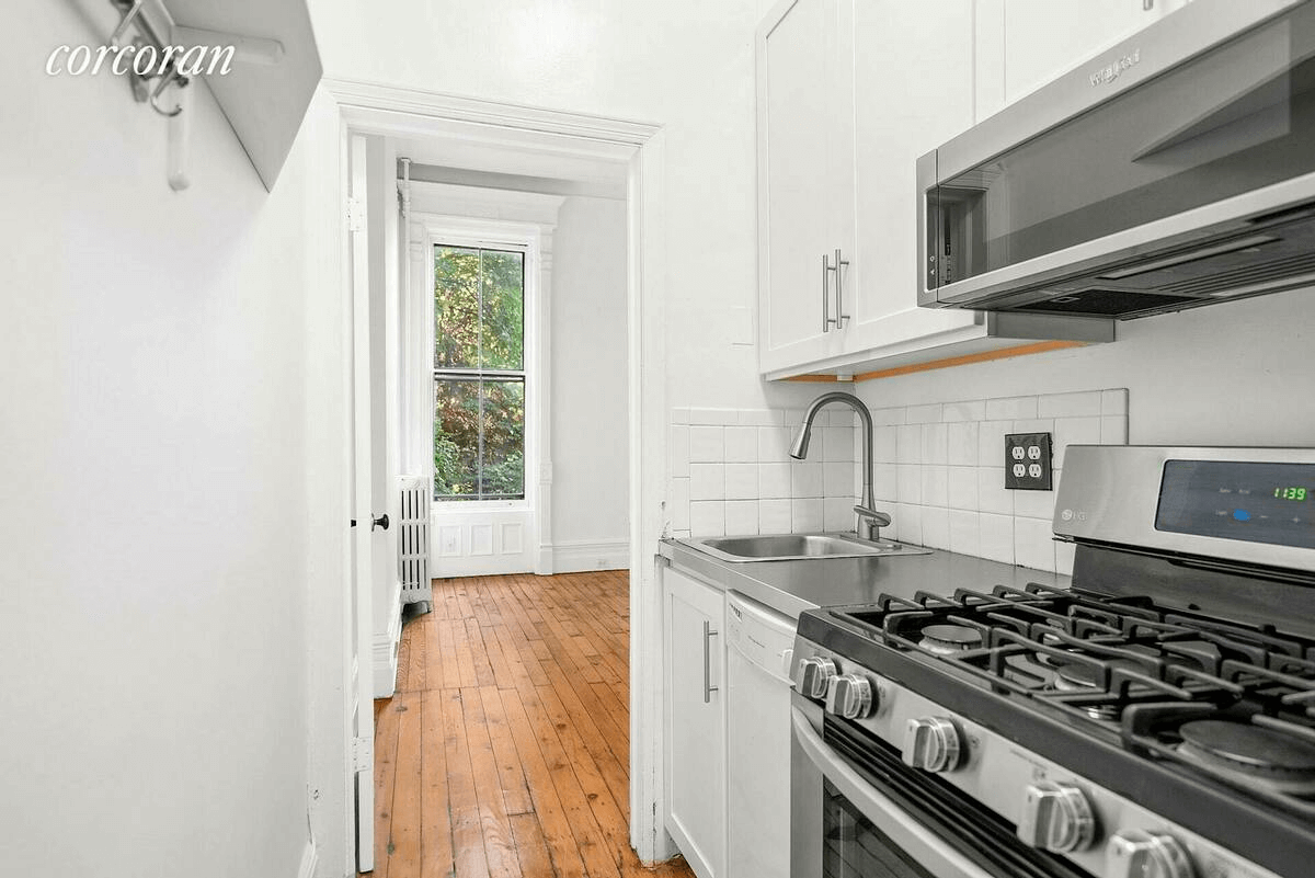 galley kitchen with white tile backsplash