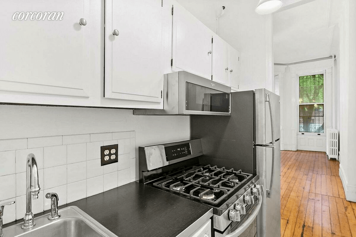 galley kitchen with white cabinets