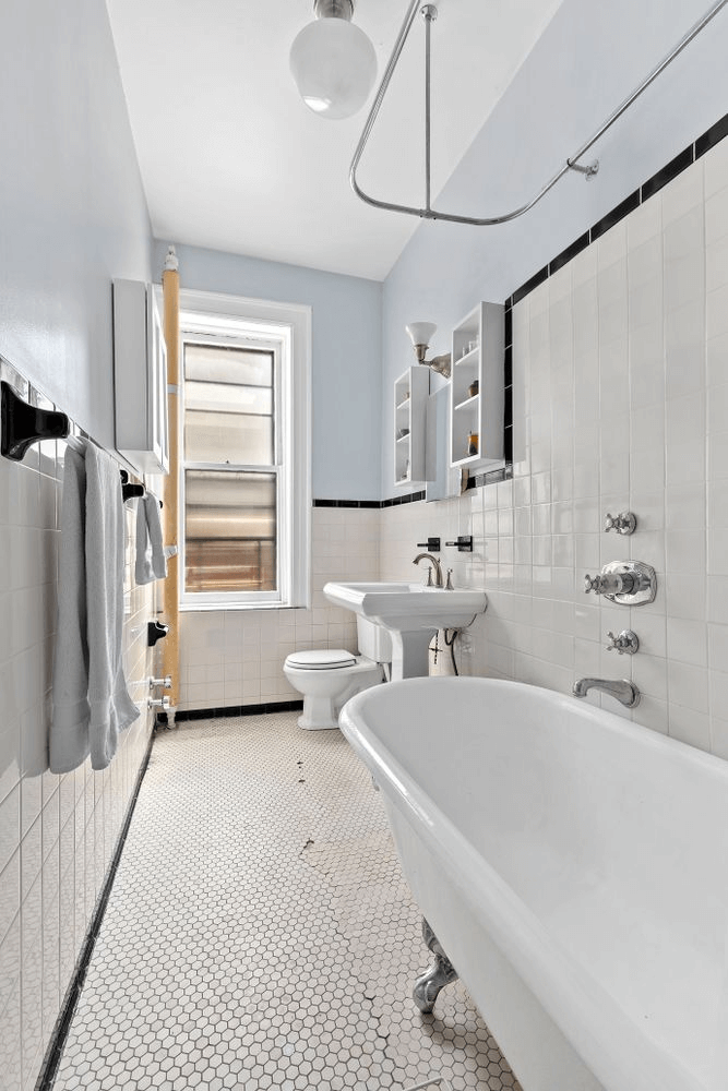 full bath with claw foot tub and white tile walls