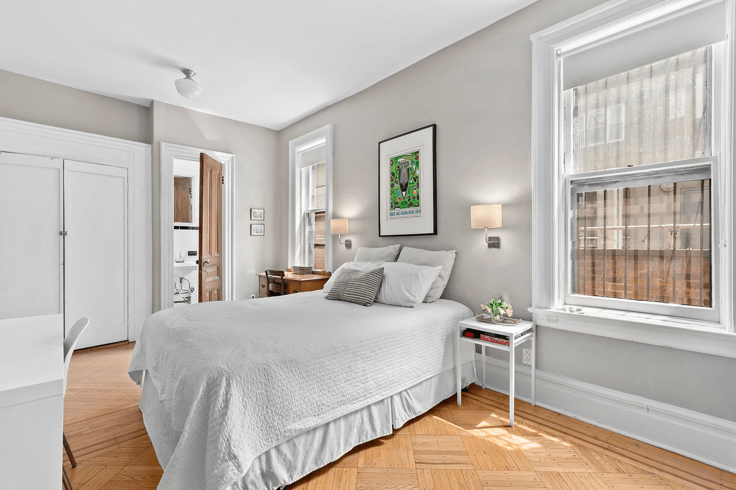 bedroom with two windows and view into en suite half bath