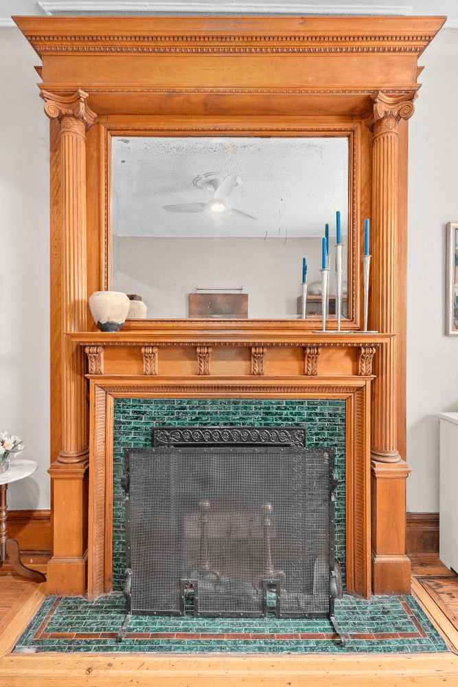 columned mantel with an overmantel mirror and a green tile surround