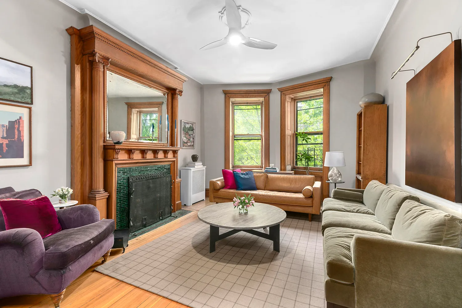 brooklyn listing - living room with a wood mantel with green tile surround