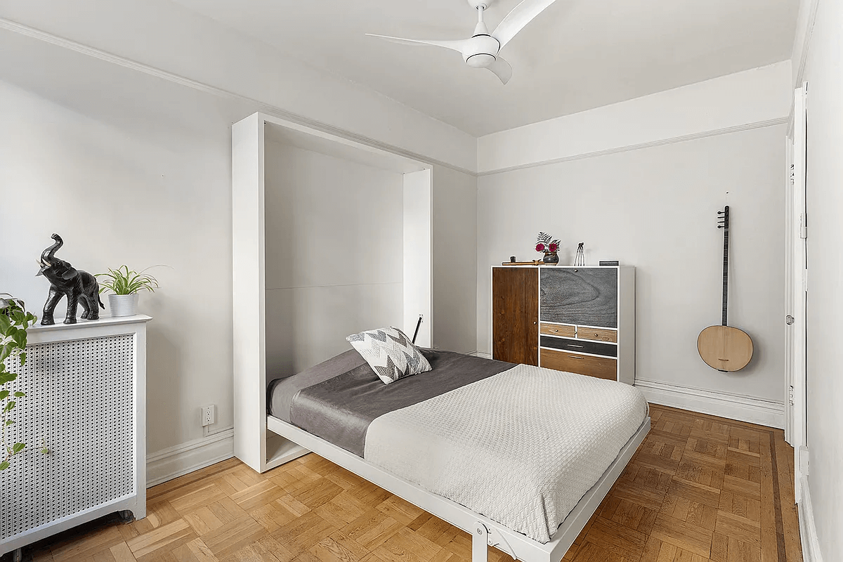 bedroom with ceiling fan and murphy bed