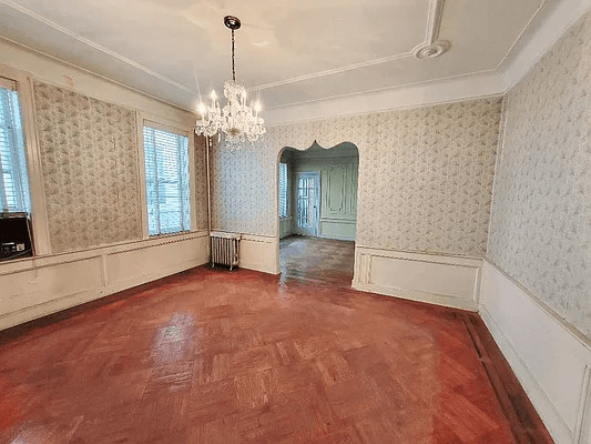 dining room with wainscoting and wood floor