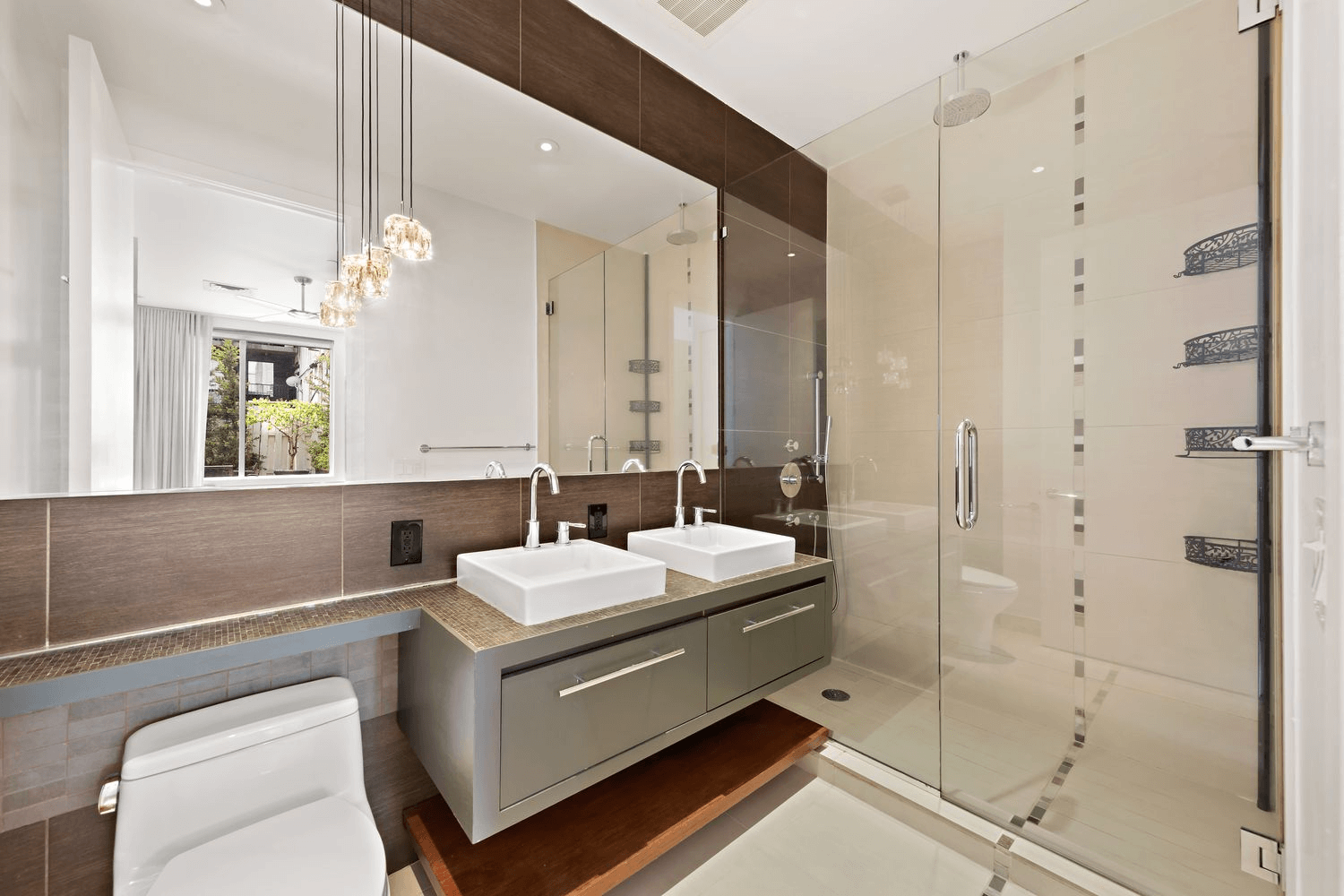 bathroom with floating double vanity and a shower