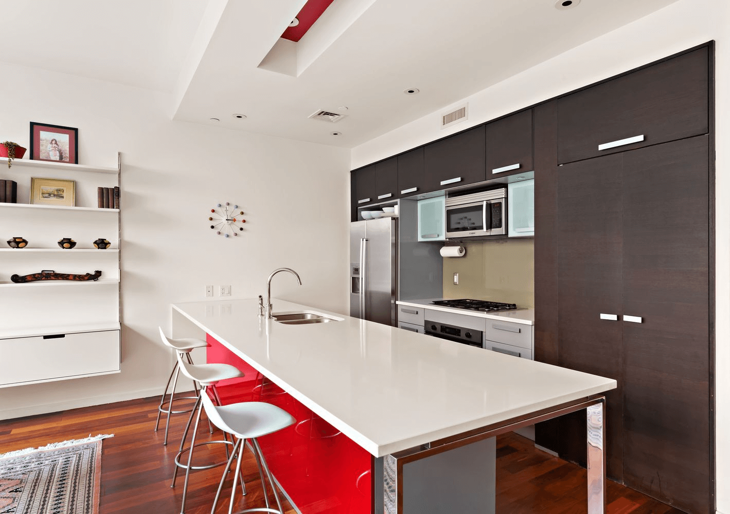 kitchen with dark cabinets and island with red cabinets