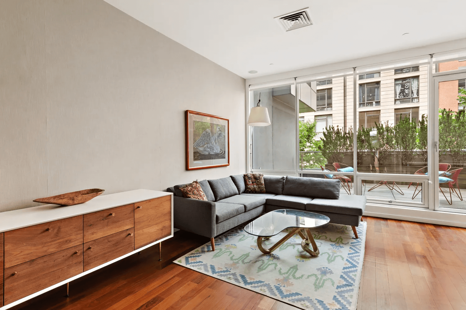 living room with wall of windows and view to terrace